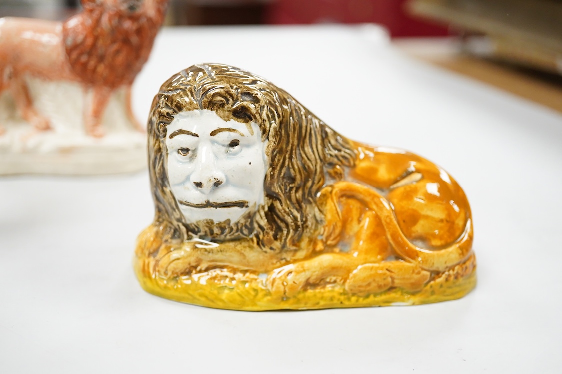 A rare Staffordshire Pearlware model of a recumbent lion, c.1810, and three Staffordshire pottery models of lions, mid 19th century, largest 11cm wide